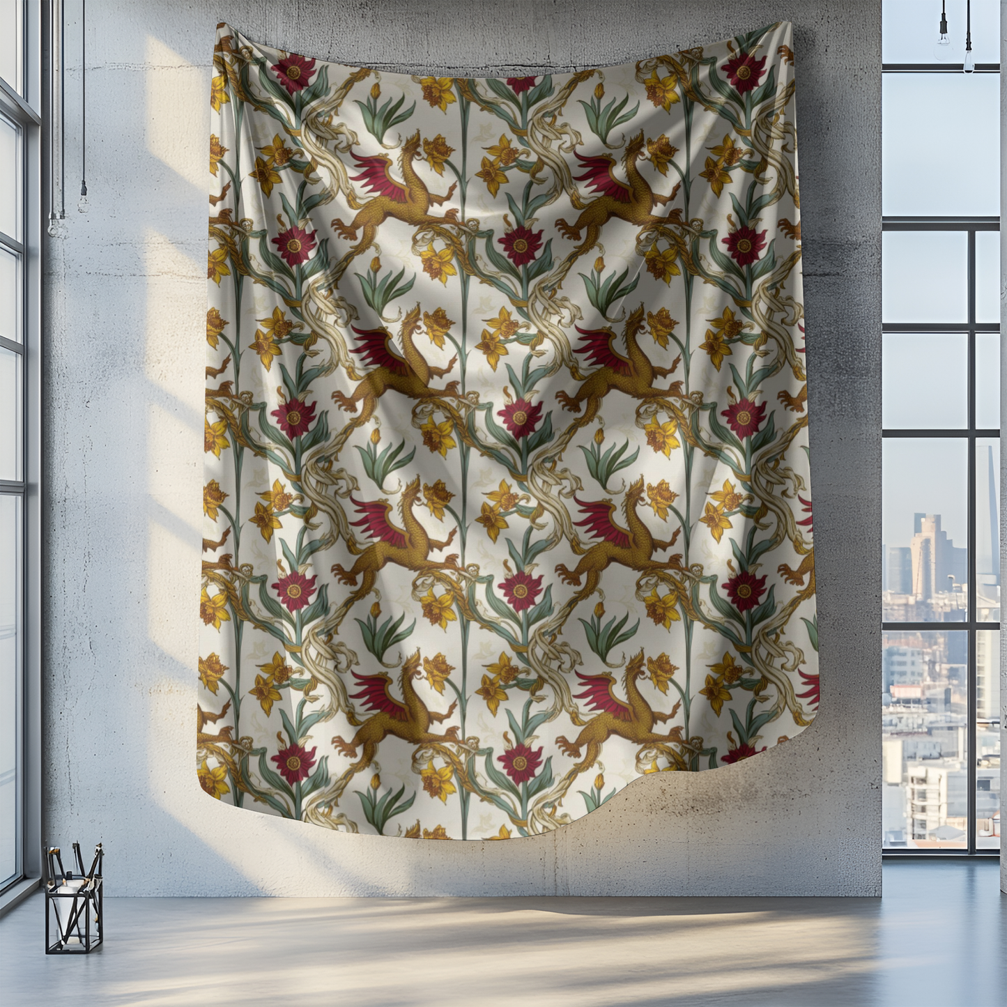 A large tapestry hangs on a concrete wall, featuring a whimsical pattern of golden griffins amid vibrant flowers and green leaves on a cream background. Bright sunlight filters through nearby windows, illuminating the intricate design in the spacious room.