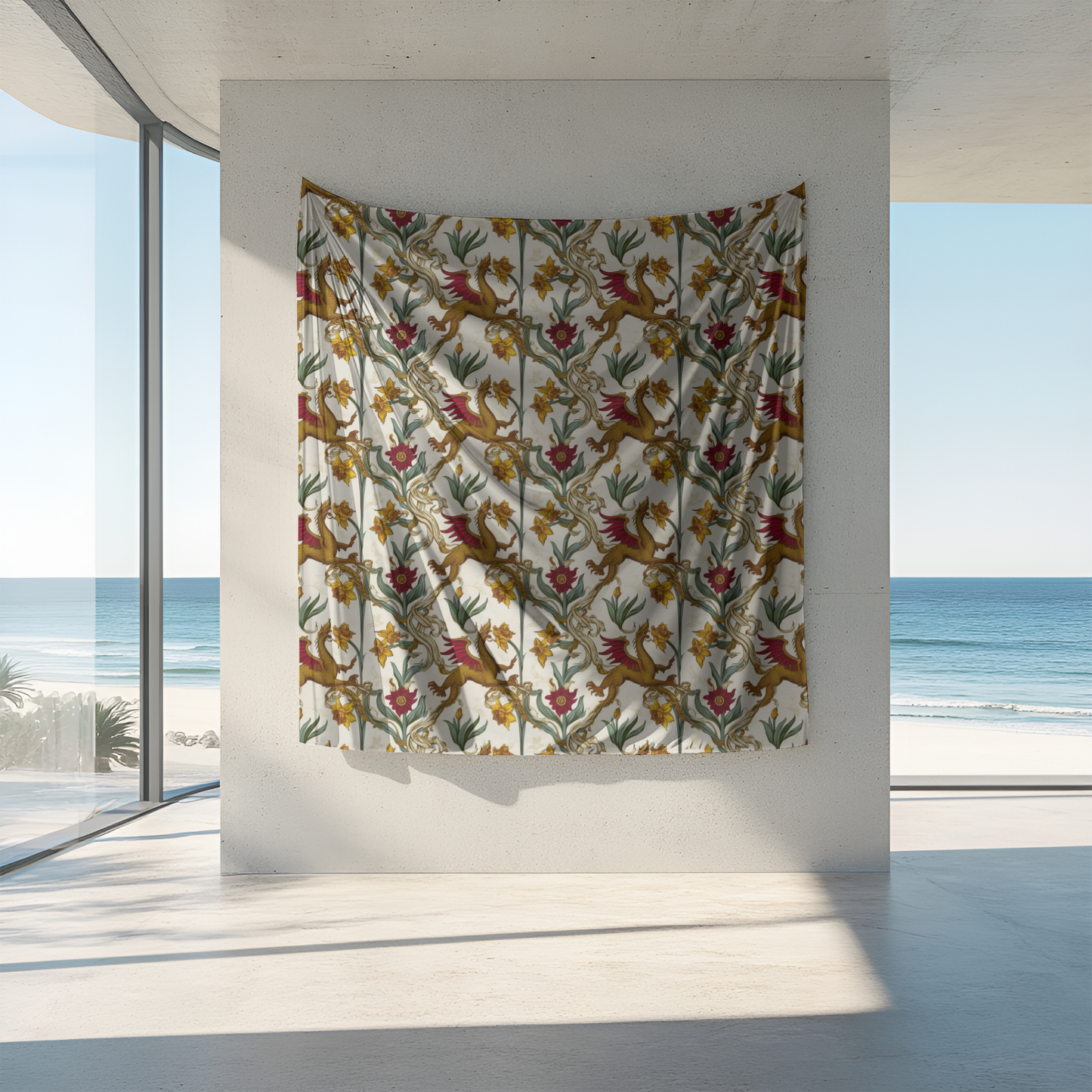 A vibrant tapestry hangs on a concrete wall, featuring a floral design with red birds and yellow flowers on a white background. Large windows reveal a scenic ocean view, with soft waves and a sandy beach in the distance, enhancing the serene ambiance.